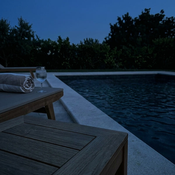 Dark poolside at night before an Eclara Ilumina cordless lamp