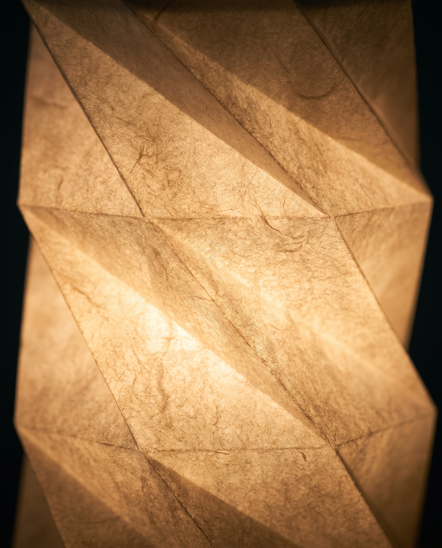 Close-up of the handmade pleated paper shade of the Lumina Fold lamp
